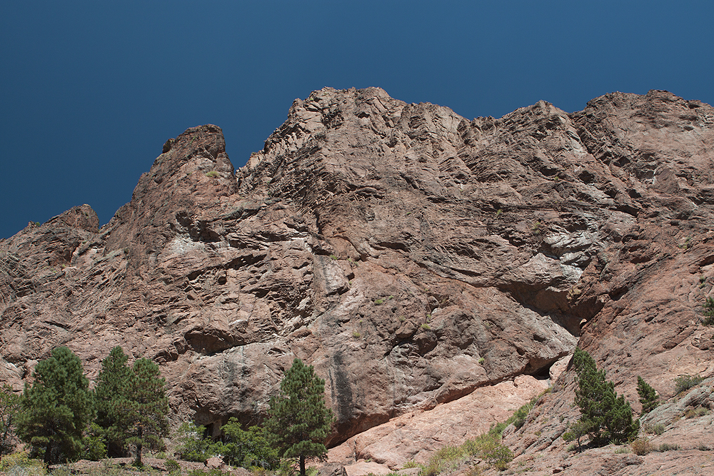 Muscular rocks lining side of box canyon