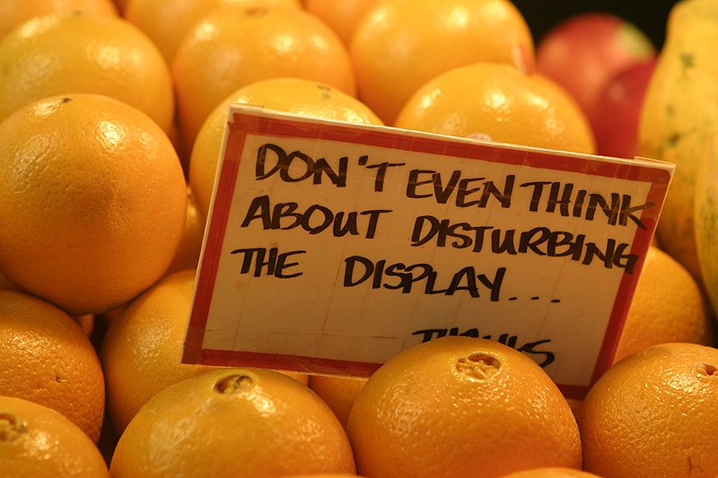 Sign on orange display, Pike Place Market, Seattle
